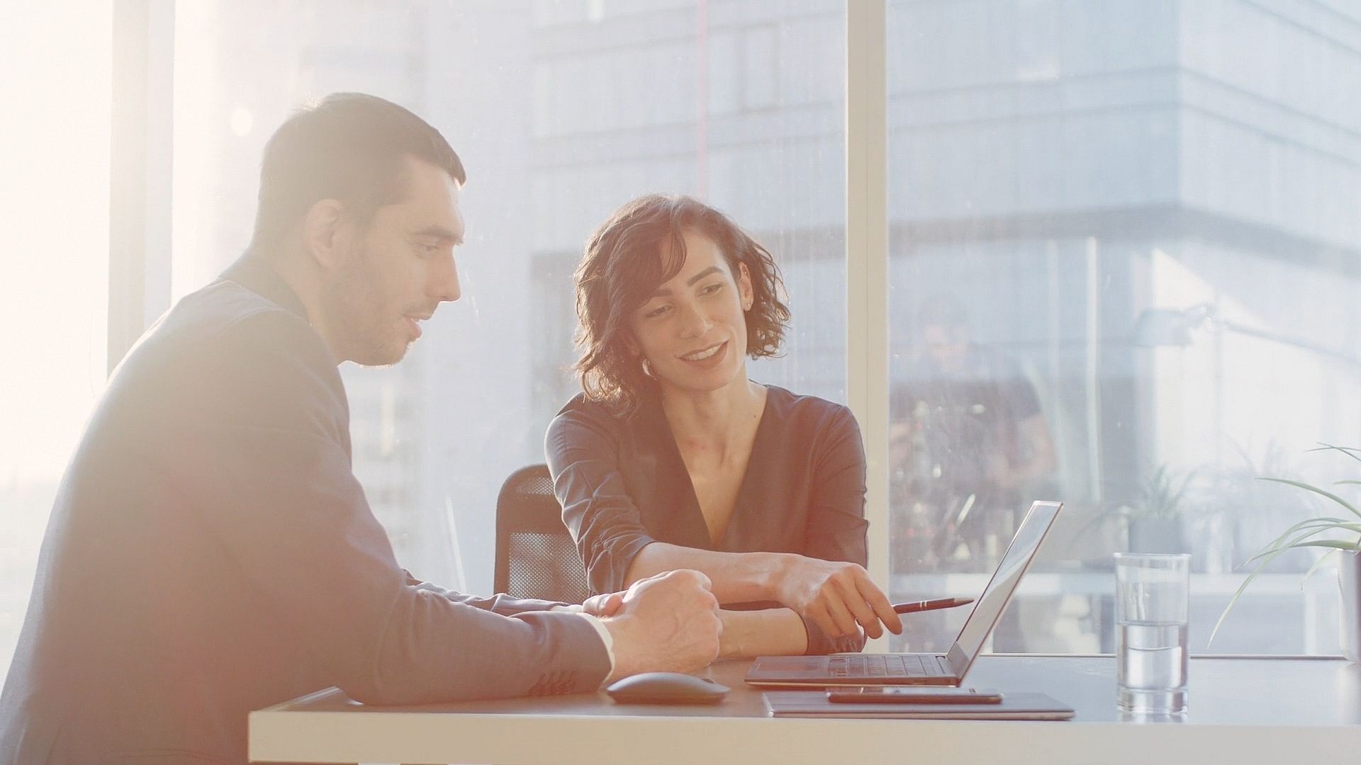 Female Top Manager and Male Businessman Sitting at the Desk Having Discussion and Working on the Laptop 1 00 00 01 18 Still001